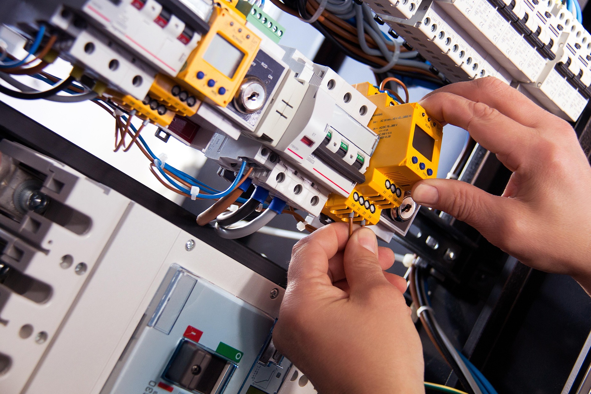 Electrician working on a control panel
